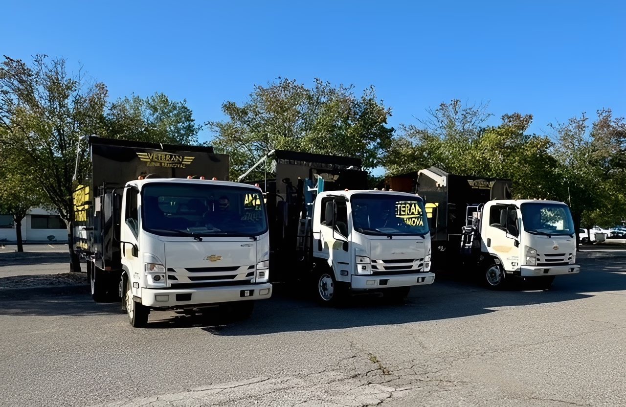 Veteran Junk Removal trucks parked side by side