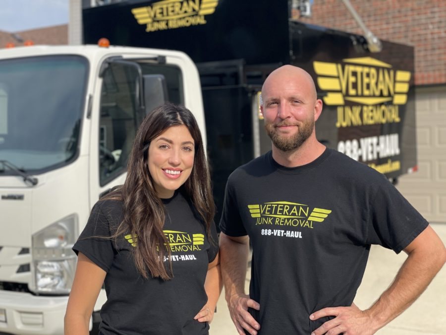Eric and Holly Bardallis in front of the Veteran Junk Removal truck